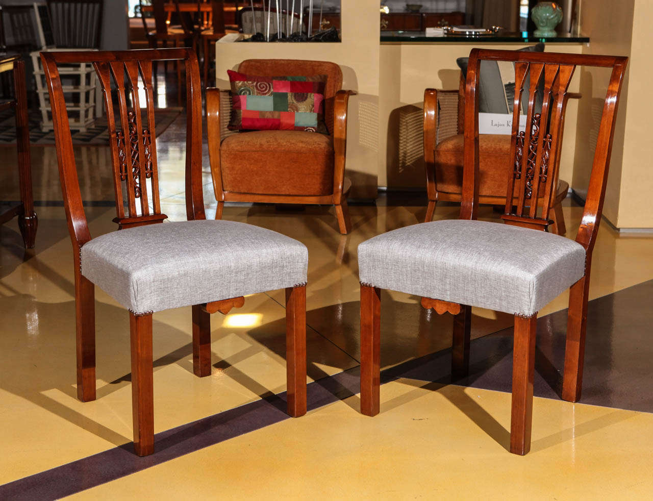 Pair of late Hungarian Secession occasional solid walnut with carved back side chairs by Lajos Kozma. New fabric.