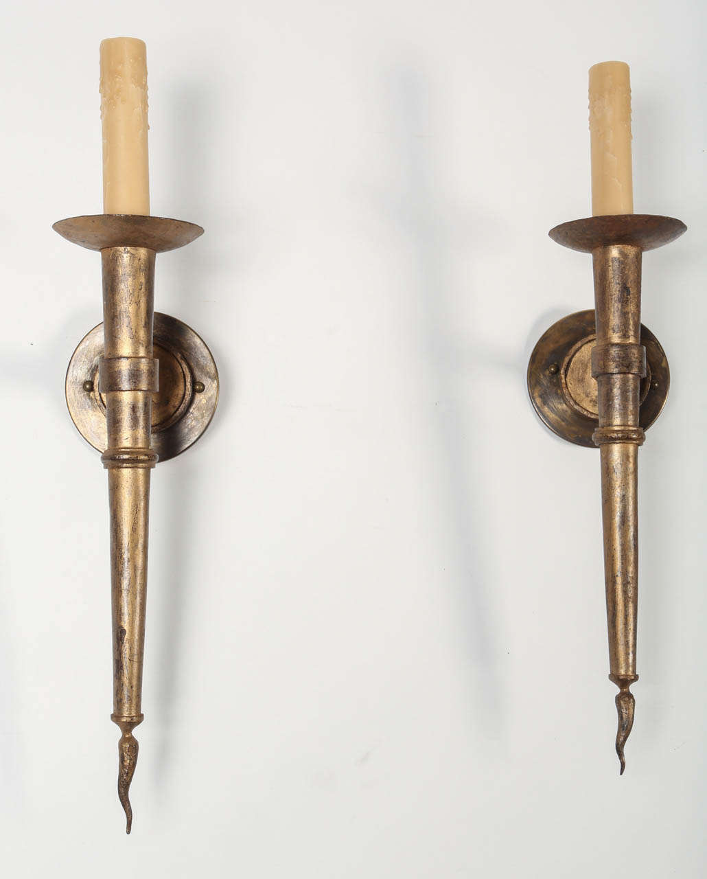 This elegant pair of French gilded iron wall sconces from the 1940's have a classic torchiere design. Their simplicity allows them to work in a variety of spaces, perfect flanking a fireplace or in a hallway. 

Base measures 5
