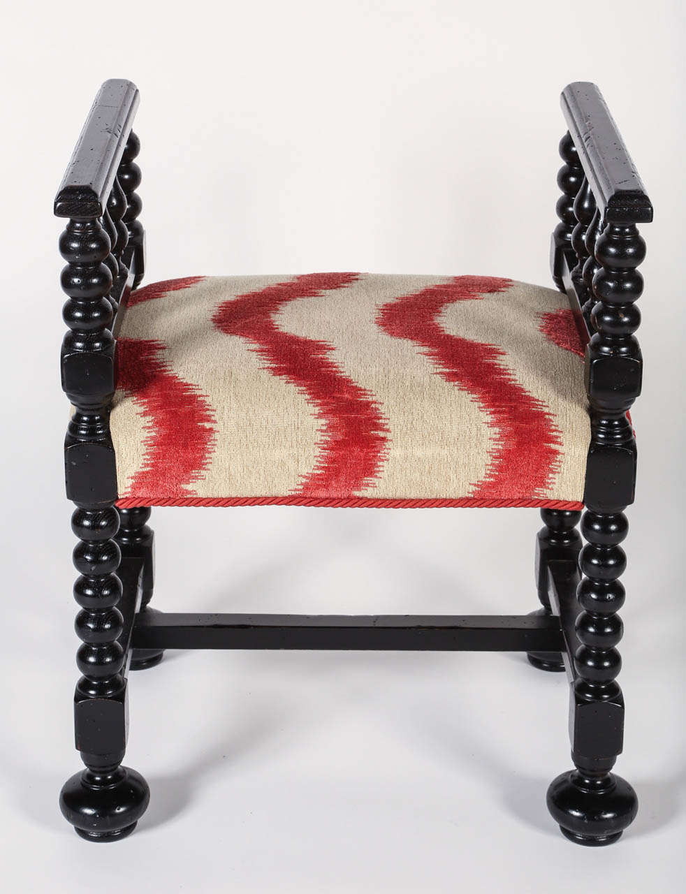 William & Mary style ebonized bench, newly upholstered in colored striped fabric.