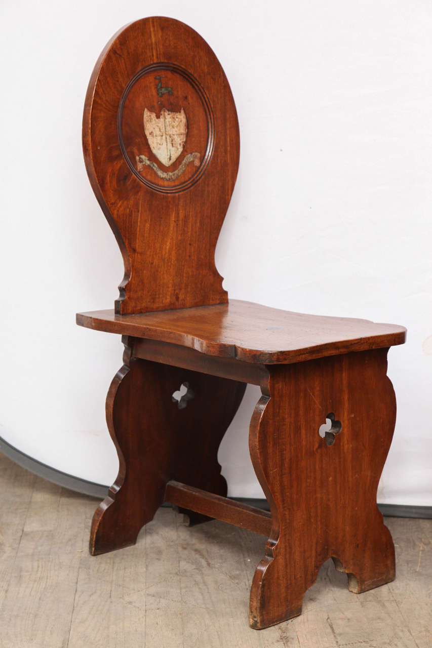 Hall Chairs handpicked by buyers at Ann-Morris, Inc.
Made of a fine antique mahogany. 

Sourced from an estate in the English countryside. The original family code of arms is still clearly visible on the chairs.