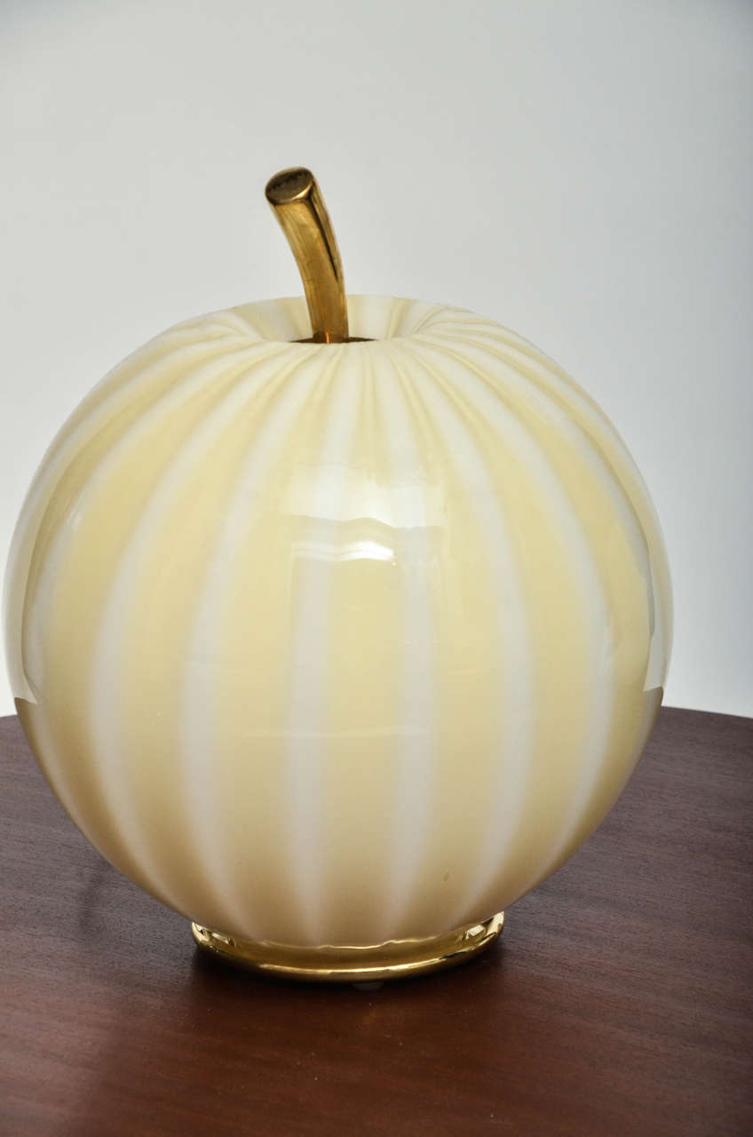 Striped Murano glass pumpkin form table lamp with brass details. One standard receptacle.