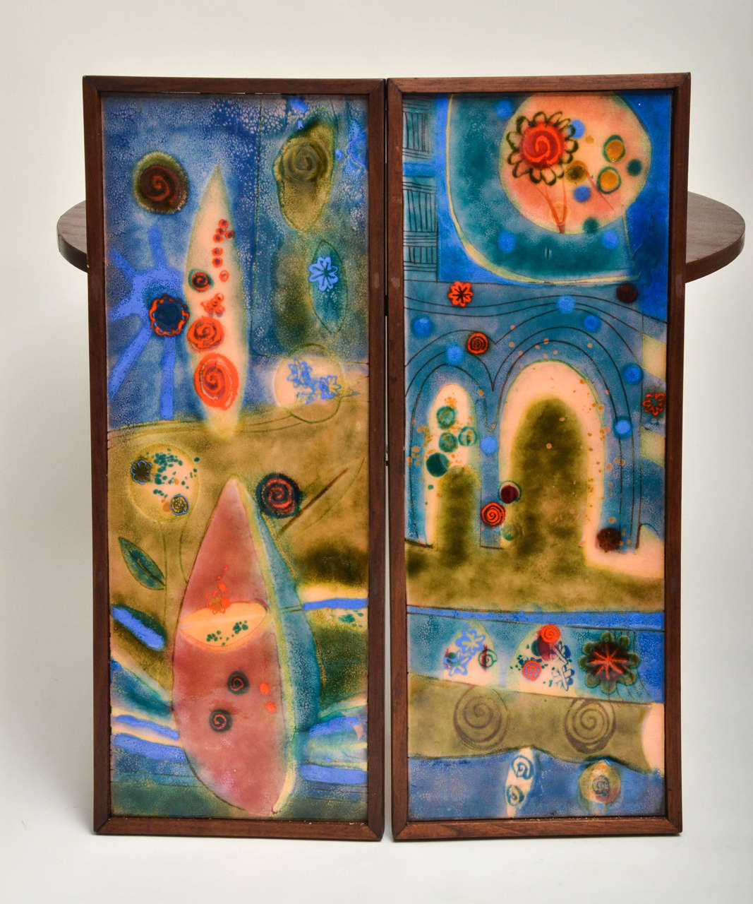 Colorful pair of enamel on copper wall art in wood frame.