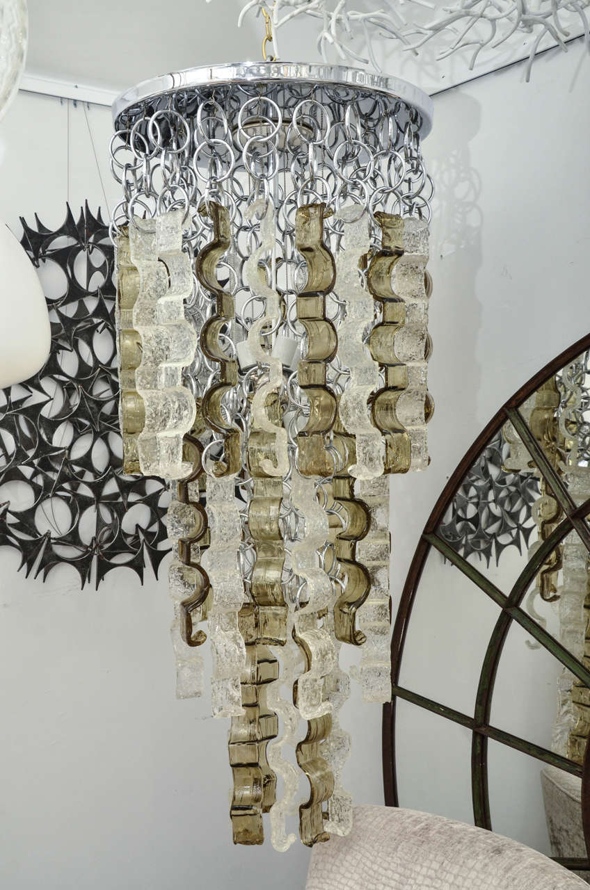 Unique Mazzega chandelier composed of textured glass elements with chrome details.