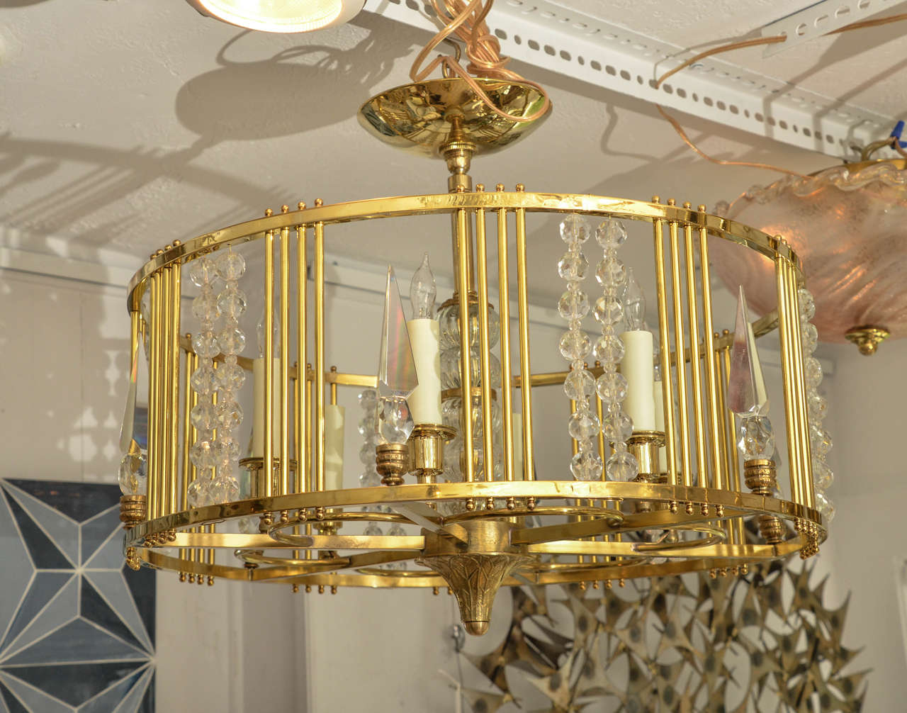 Drum form brass chandelier with decorative bead and prism details.