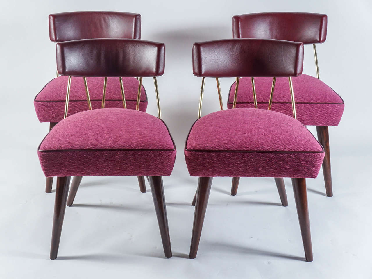 Billy Haines’s Drum chair upholstered in burgundy leather (back and welt) and fuschia woven fabric (seat). Dark wood tapered, splayed legs and brass back detail. Excellent vintage condition.