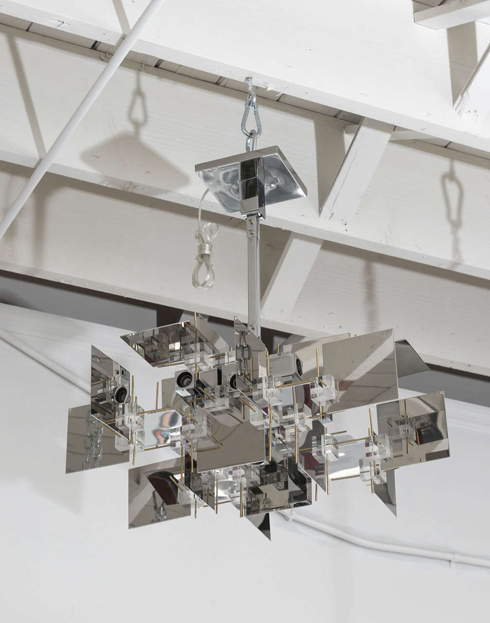 Totally refurbished 1970s Gaetano Sciolari chrome and Lucite chandelier. A true vintage piece that piece has been totally refurbished and rewired. A beautiful cubist sculptural form that would definitely enhance a modern, Midcentury or Classic