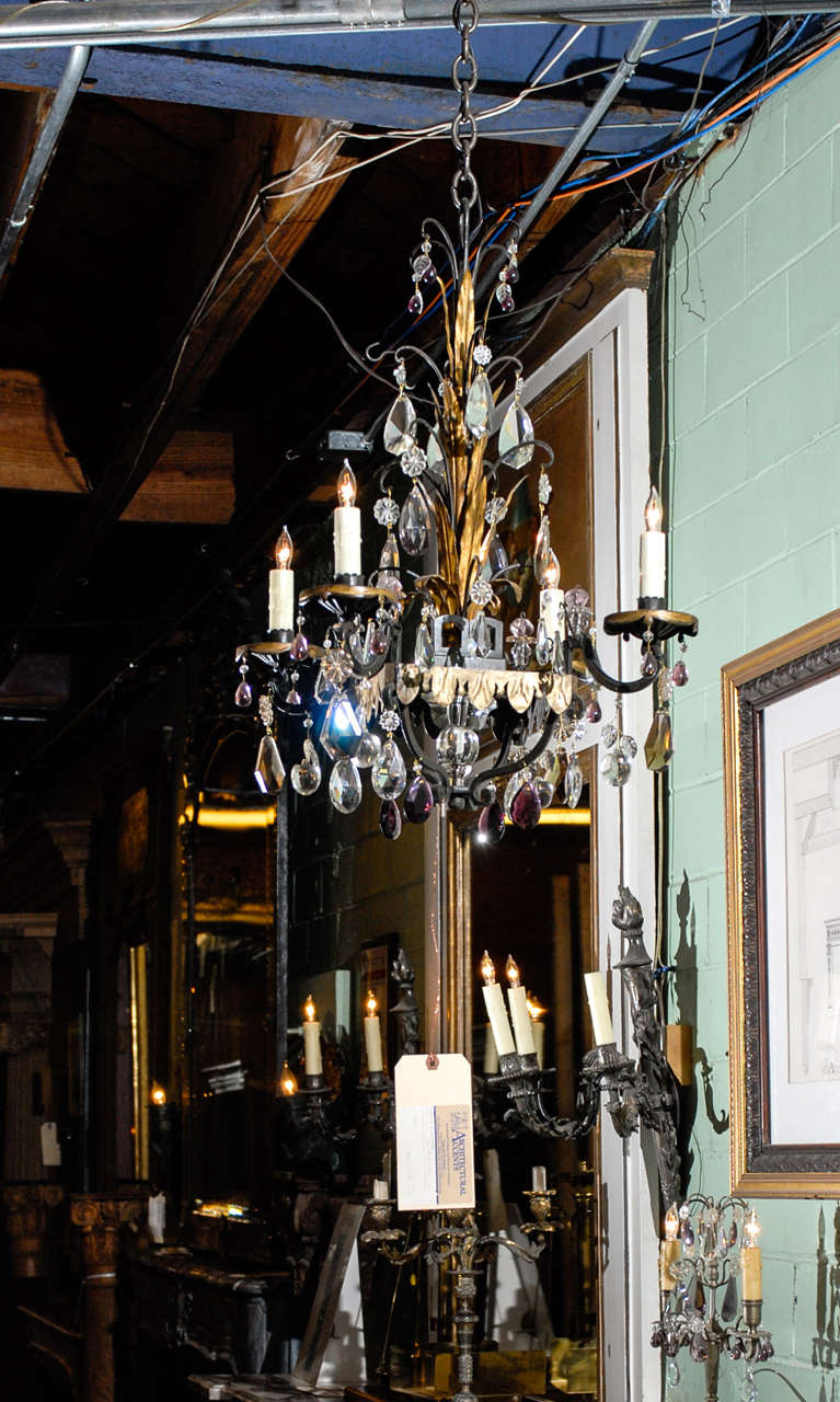 Wonderful French gilded and painted iron chandelier with four beeswax candelabra sleeves. This fanciful fixture is draped with both clear and amethyst crystals.  