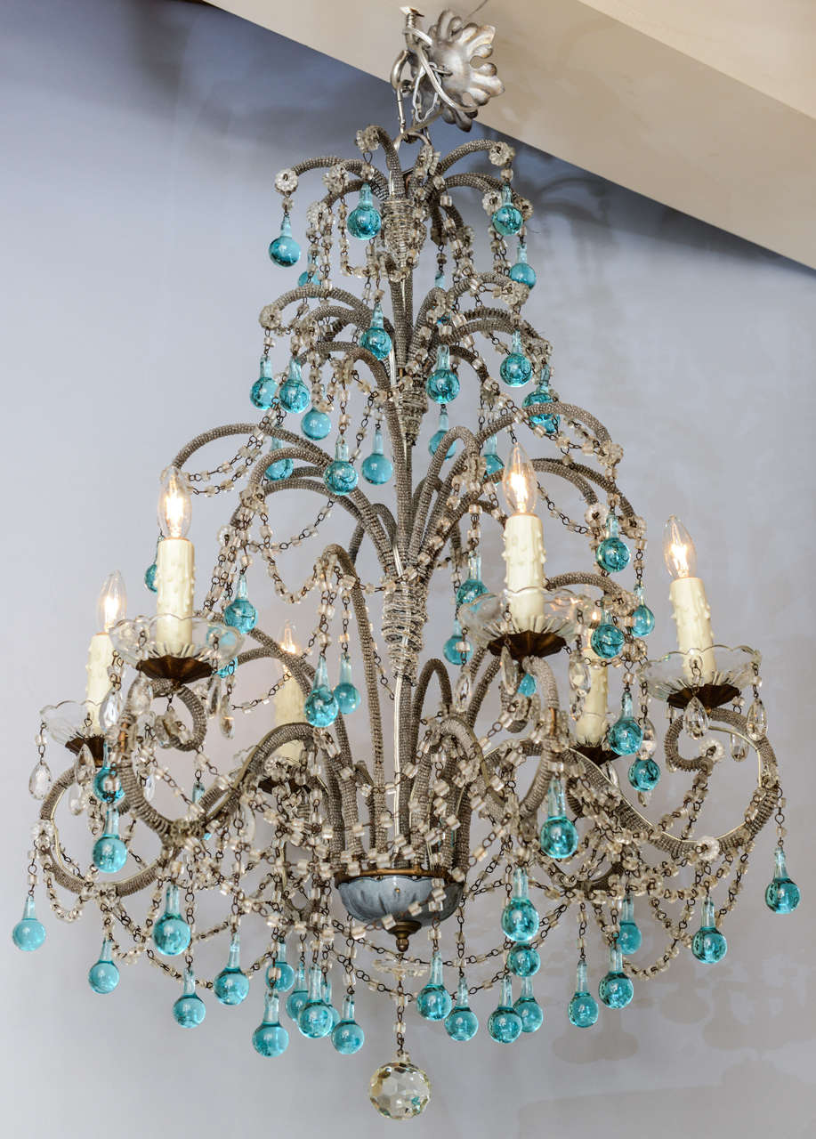 Unusual chandelier, having scrolling bead-wrapped iron frame, six candlepots with glass bobeches, the entire fixture draped with glass beads and turquoise-blue crystal balls.