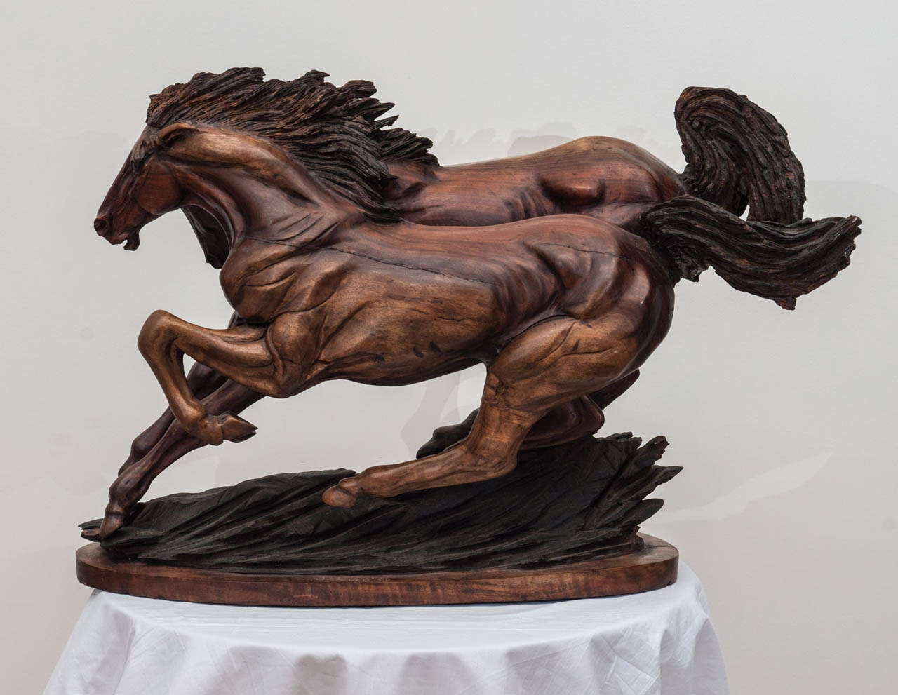 A dynamic sculpture carved in wood. the work is signed and dated '88.