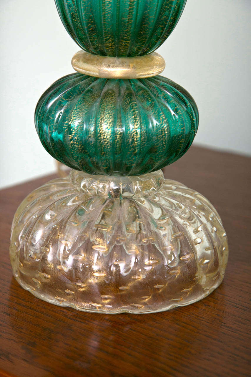Unique gold blown peacock green colored lamps each comprised of six blown parts, stamped by Seguso, circa 1950s.
Height to the top of the glass ball is 21