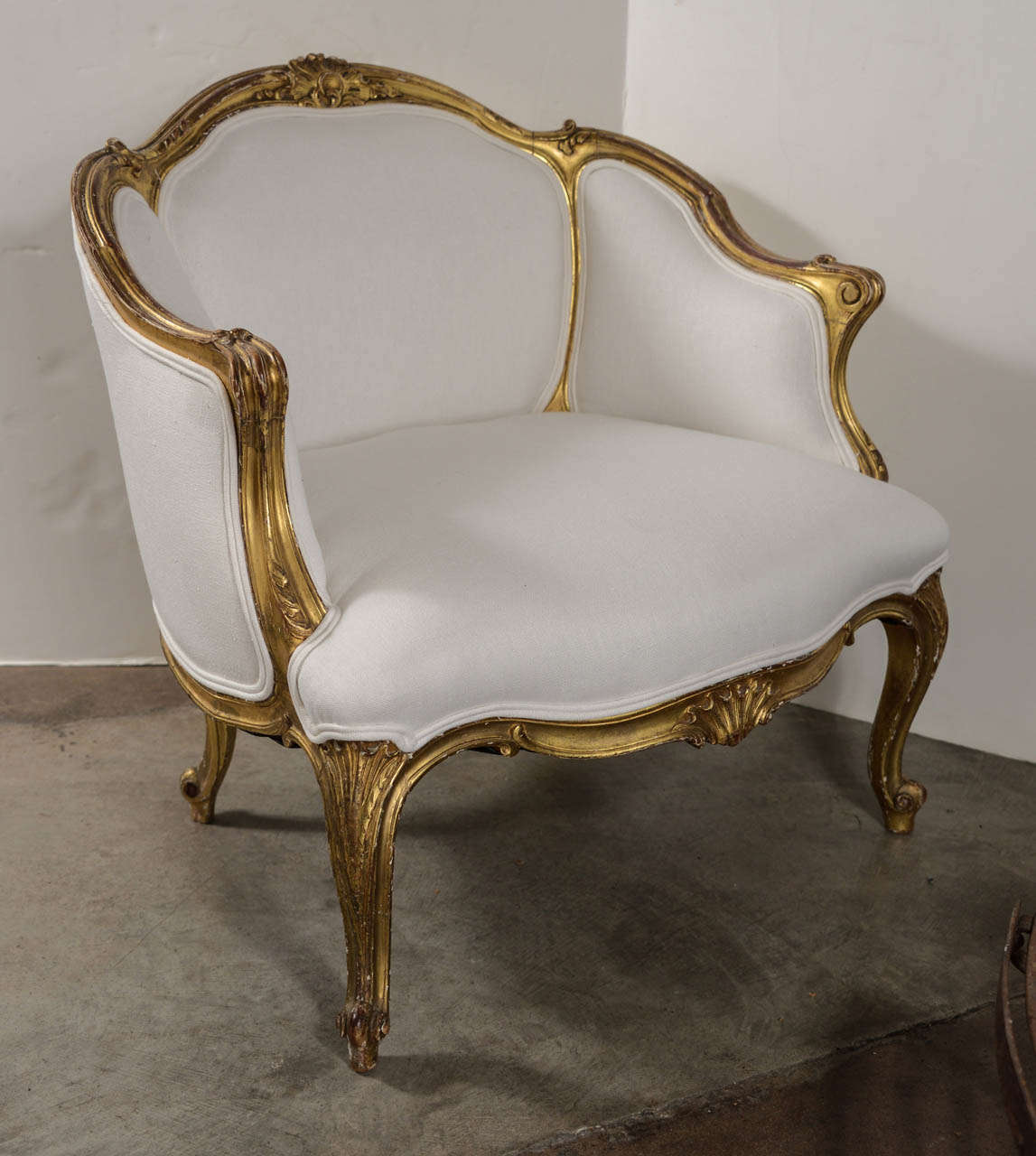 18th century walnut gilt chair reupholstered in white linen. Rich patina with wonderful proportion and size. Great carving.