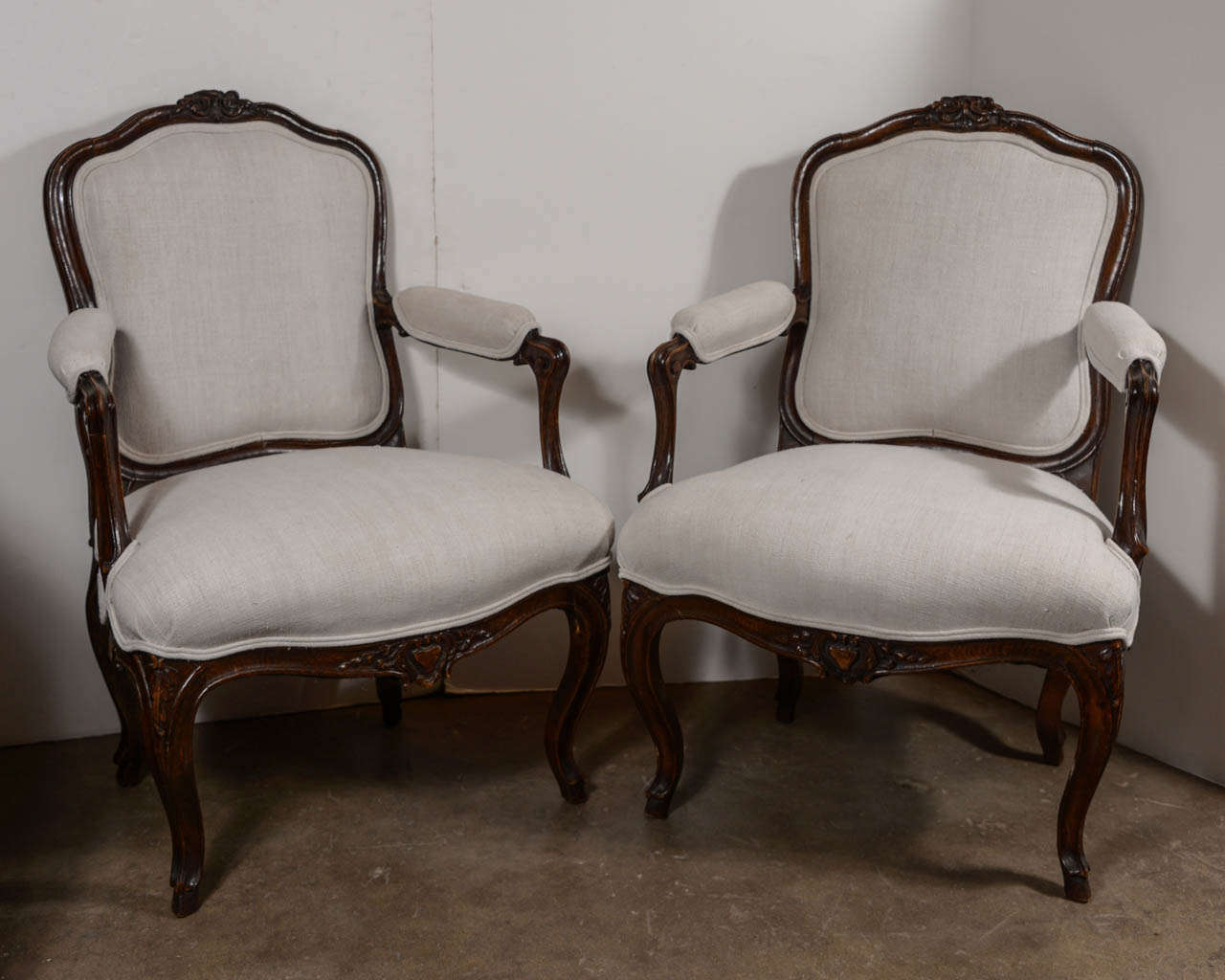 Pair of 18th century Louis XVI walnut chairs with newly upholstered antique linen.
