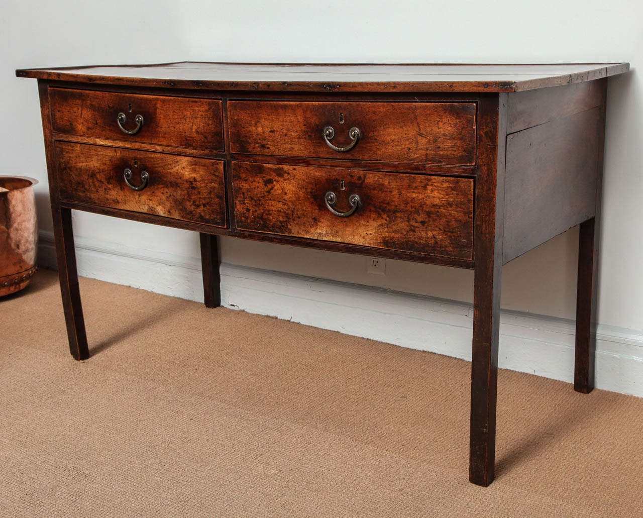 Very fine English solid walnut hall table, the two plank top with raised gallery edge over two rows of drawers, standing on square tapered legs, the whole a study in understatement and possessing a most luscious color and patina.