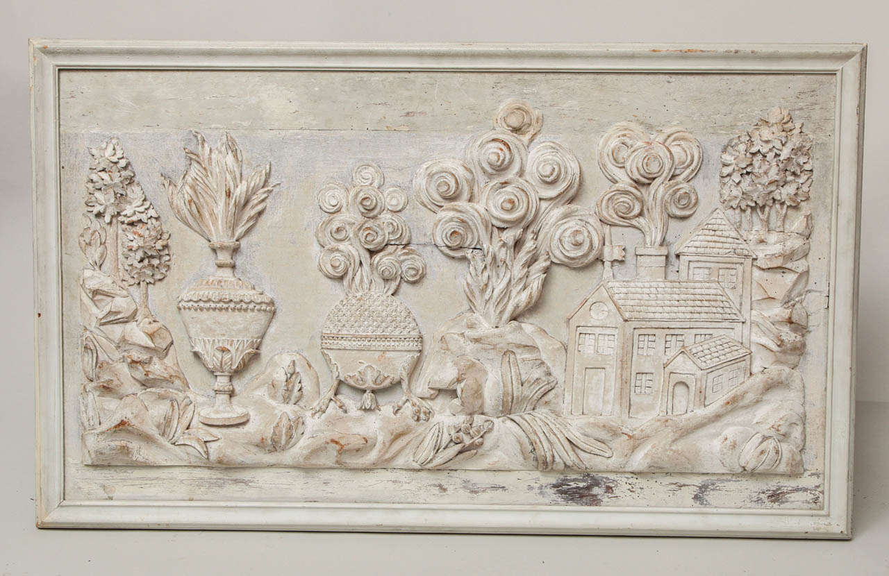 Most unusual carved over door panel, probably Provence, depicting a fanciful assortment of images including a flaming urn, a billowing incense burner, an erupting volcano and a chateau with smoking chimney, in original lime wash surface.