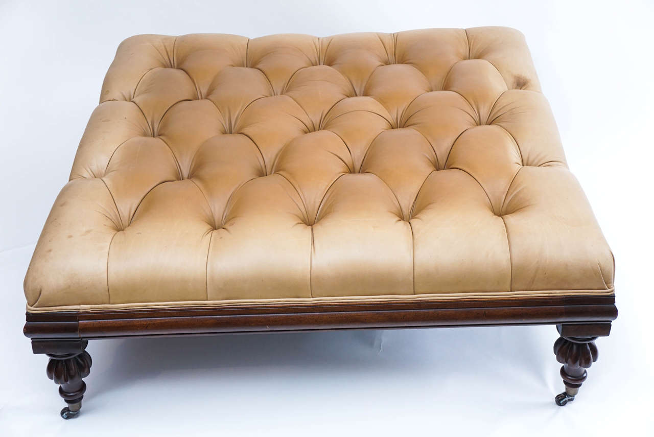 This strikingly large ottoman can be used as it apparently was, as a combination ottoman or coffee table with tray. The worn, tufted leather creates the impression of a piece with age and sophistication. It is structurally very sound, luscious to