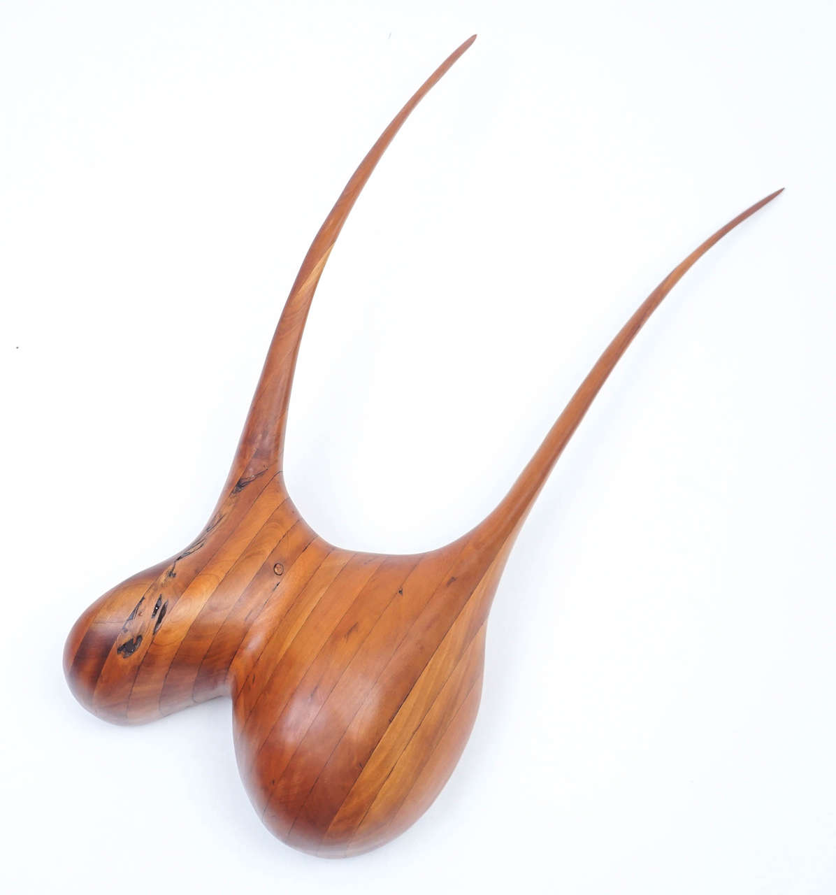 Impressive wood carving in rich cherry suggests the sensual artistry of Wendell Castle. This example is purposefully hung on an angle, its abstract form open to interpretation. The organic design adds depth no beauty to your wall décor.