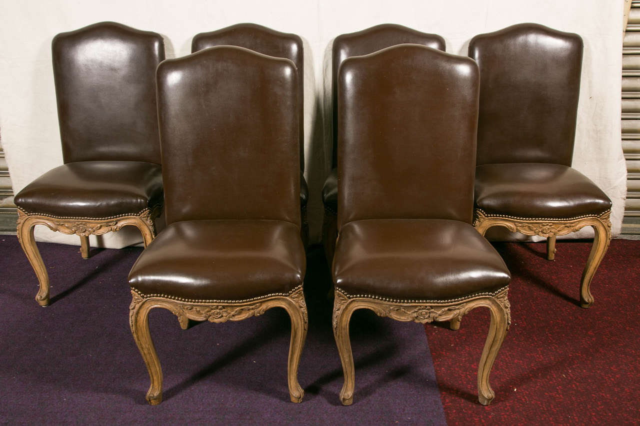 Large dining Chairs , painted wood , covered with a chocolate moleskine,
France 20 th