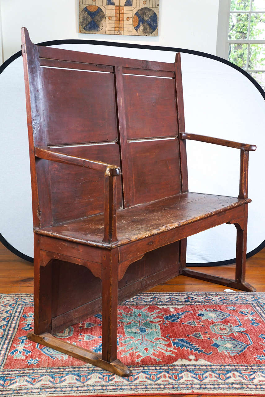 Exceptional is a good way to begin to describe this Welsh sledge foot George III settle. Its design is simple yet very unusual. The red paint is worn and authentic. A home in a mudroom, table side or den would be perfect for this early seat.