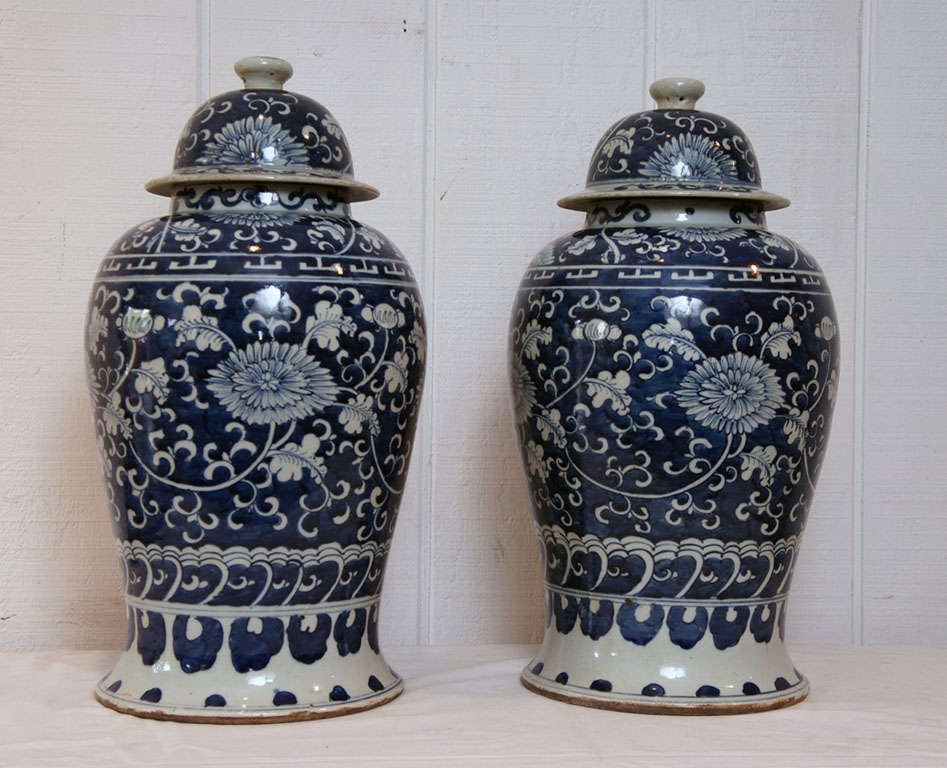 Pair of Blue and White Porcelain Covered Vases. Baluster form with hand painted Crysanthemum floral motif. Created in Jingdezhen, China, center of Imperial Porcelain manufacture and location of the Emperors' kilns.