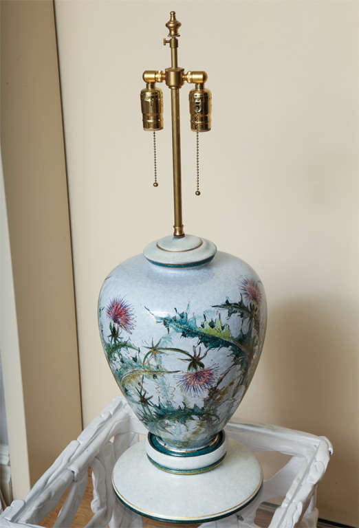 A pair of polychromed decorated porcelain vases with thistle motif now mounted as lamps with custom wooden bases.