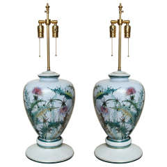 A pair of polychromed decorated porcelain lamps
