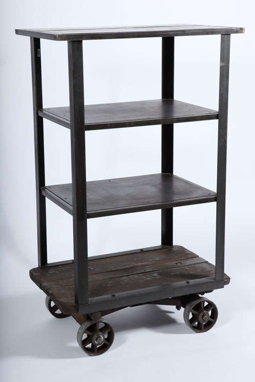 Cast iron base and casters. Solid welded steel frame with wooden bottom shelf.