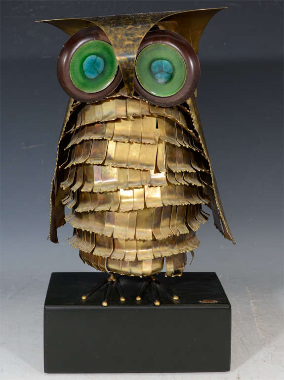 A vintage Curtis Jere sculpture of an owl. The owl itself is done in metal with large green and blue enameled eyes. IT is signed and dated on the base