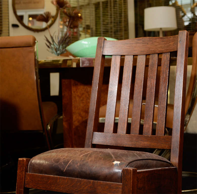 An antique wooden arts and crafts rocking chair with original leather upholstered cushion. The leather has a distressed patina and the piece bears the red Stickley mark on the back.

Reduced from $1800.00