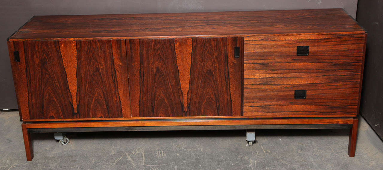 Vintage 1960s Rosewood Credenza from Denmark. 

This Vintage Console Cabinet has four draws and two sliding doors. The doors are beautifully designed. They sit side by side but when you want to open one you gently push back on the door and it