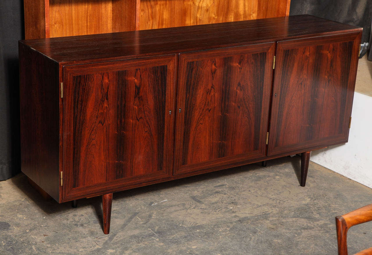 Vintage 1960s Kai Winding Sideboard from Denmark.

This Vintage Cabinet is in like-new condition. Each hinged door has an adjustable shelf behind it, and the interior is made from mahogany, which is a natural bug repellant. Great for the living