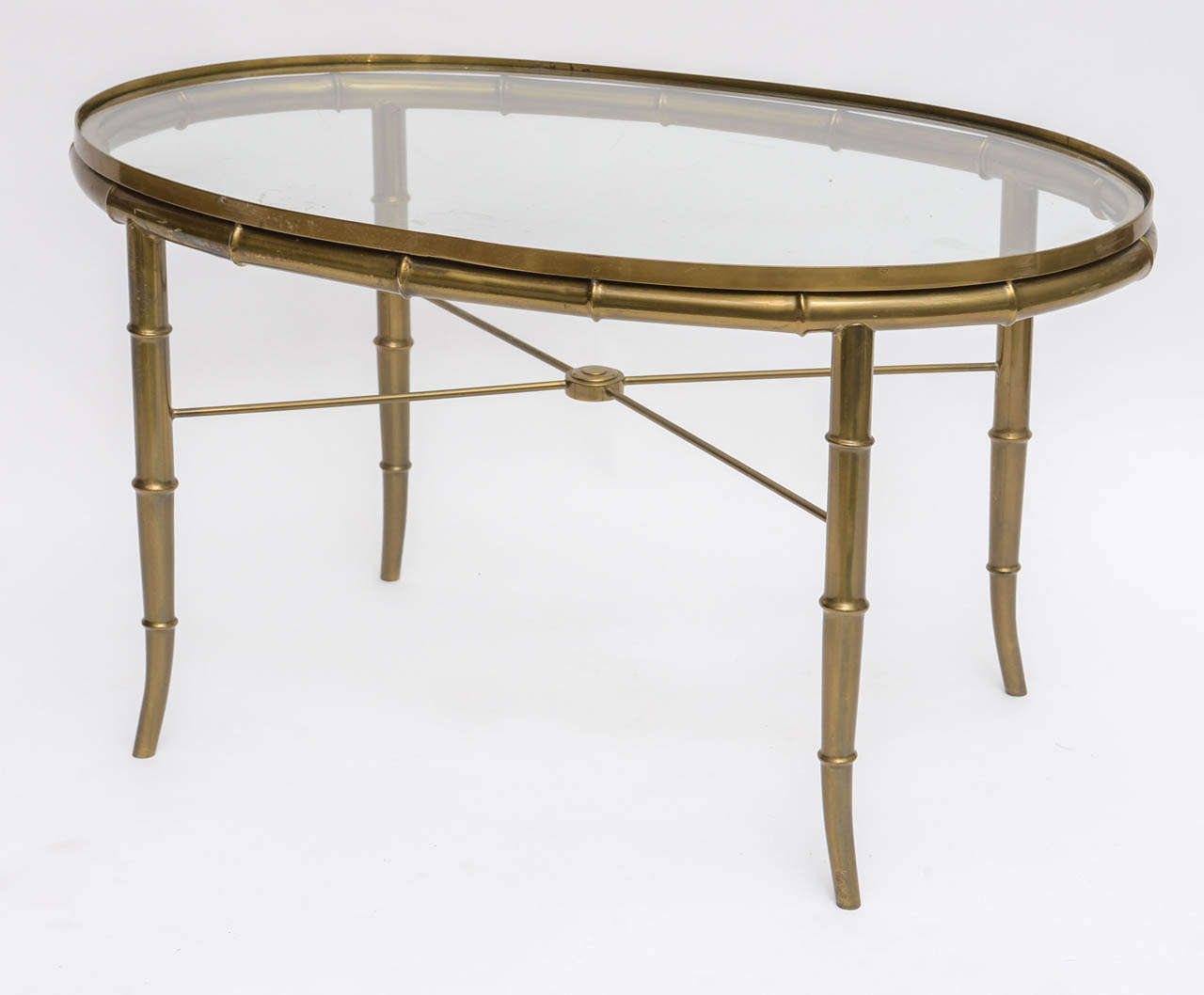 High style oval Italian brass cocktail table with bamboo motif.