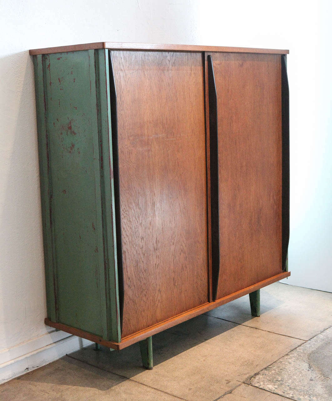 jean prouve's armoire in original condition. sliding doors reveal a hanging rack and 4 adjustable shelves.