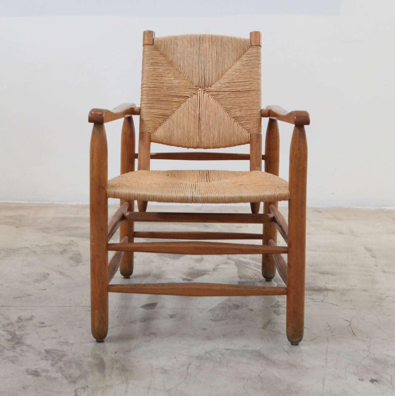 Charlotte Perriand's oak and rush chair, designed in 1935. 2 of 3.
*sold individually.