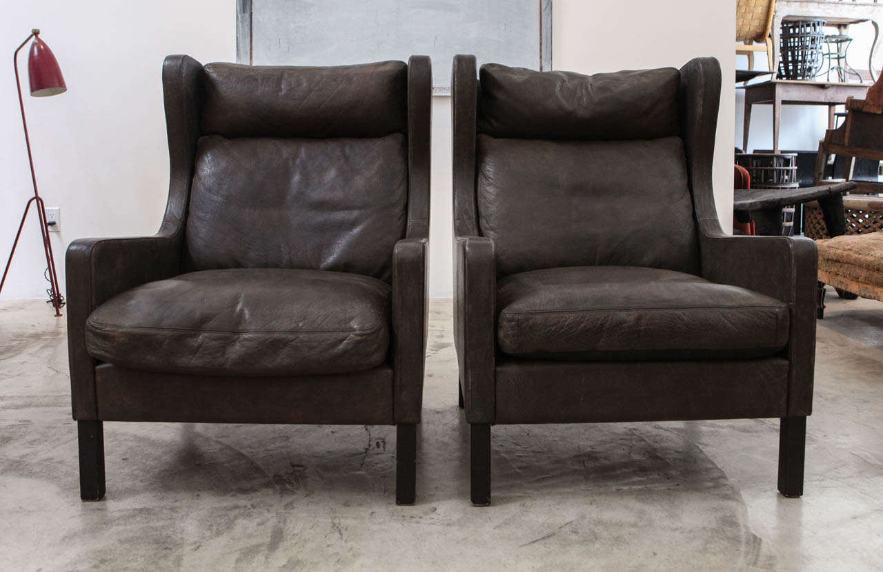 We call the color of this leather ashy-elephant. a pair of fantastically handsome and super comfortable wing backs from denmark. the condition is original. no repairs. *sold only as a pair. these are not borge mogensen wings, even though many people