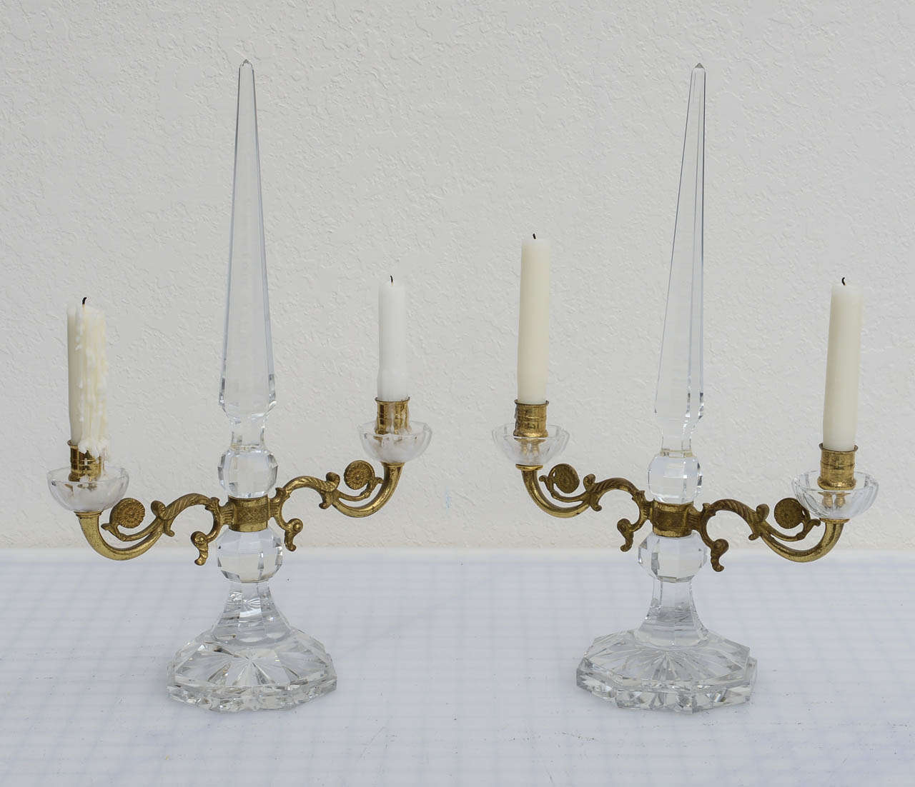 Stunning pair of crystal and bronze table candelabras.    Wonderful detailed bronze arms with .cut crystal obelisk's rise from the center with cut crystal disks and detailed work continuing to the base.

Originally $ 3,850.00