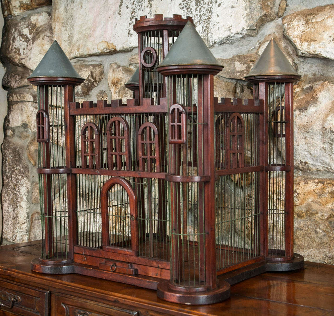 Constructed to look like a castle, this large wood and wire birdcage is an attractive bit of whimsy that brings humour to the situation of avian housing. Bird pets were highly popular in Victorian England where the business of caging was raised to