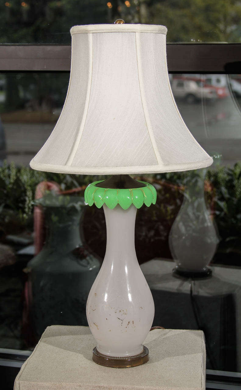 An early 20th century French Opaline lamp base with green glass detail and vestiges of original gilding.