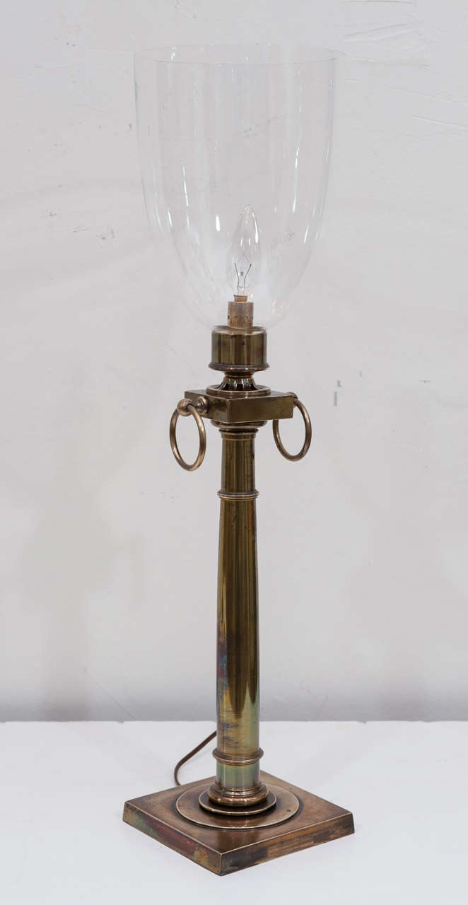 An elegant and sophisticated pair of Regency style hurricane lamps
with patinated brass column and hand blown shades.