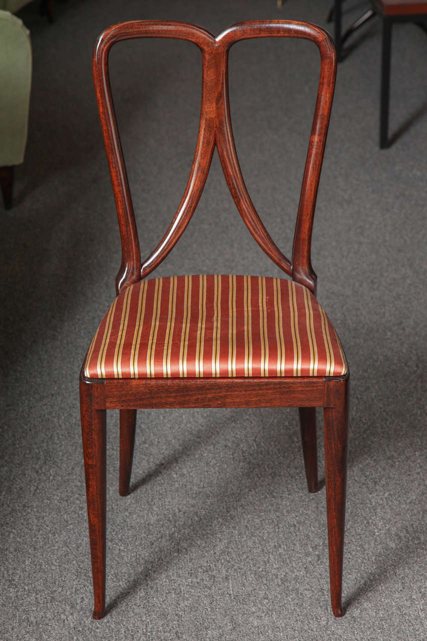 Stunning set of eight carved mahogany dining chairs designed by Guglielmo Ulrich, made in 1940s in Milan.
Beautiful chairs, nice proportions, charming foot in front legs.
Rare model to find.
  