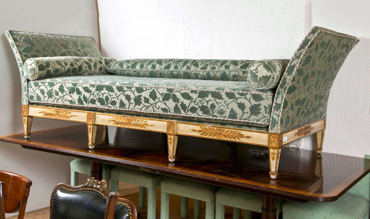 The finest Italian Antique 19th Century Day Bed. The tapering legs supporting a frame of finely painted and detailed supports. The green and white leaf design upholstery of the finest quality with decorative welts. The gold leaf is simply the