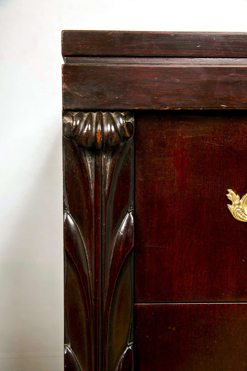 A fine pair of custom quality bachelor chests by John Stuart. Custom quality pair of four drawer chests each flanked by carved column-form sides. All drawers having solid bronze pulls. Finely polished commode tops. The casing on bracket feet. Can