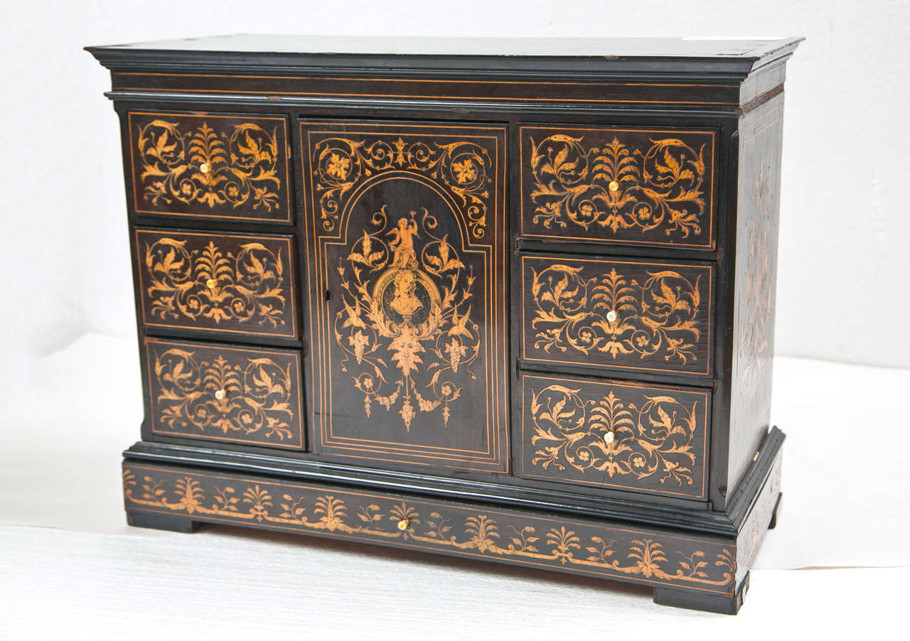 A finely decorative designed diminutive Chinese chest or jewelry box the 19th century. Wonderfully detailed inlays all-over this ebonized antique box.