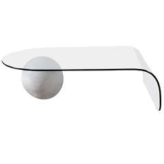 A Glass Coffee Table with a Plaster Ball