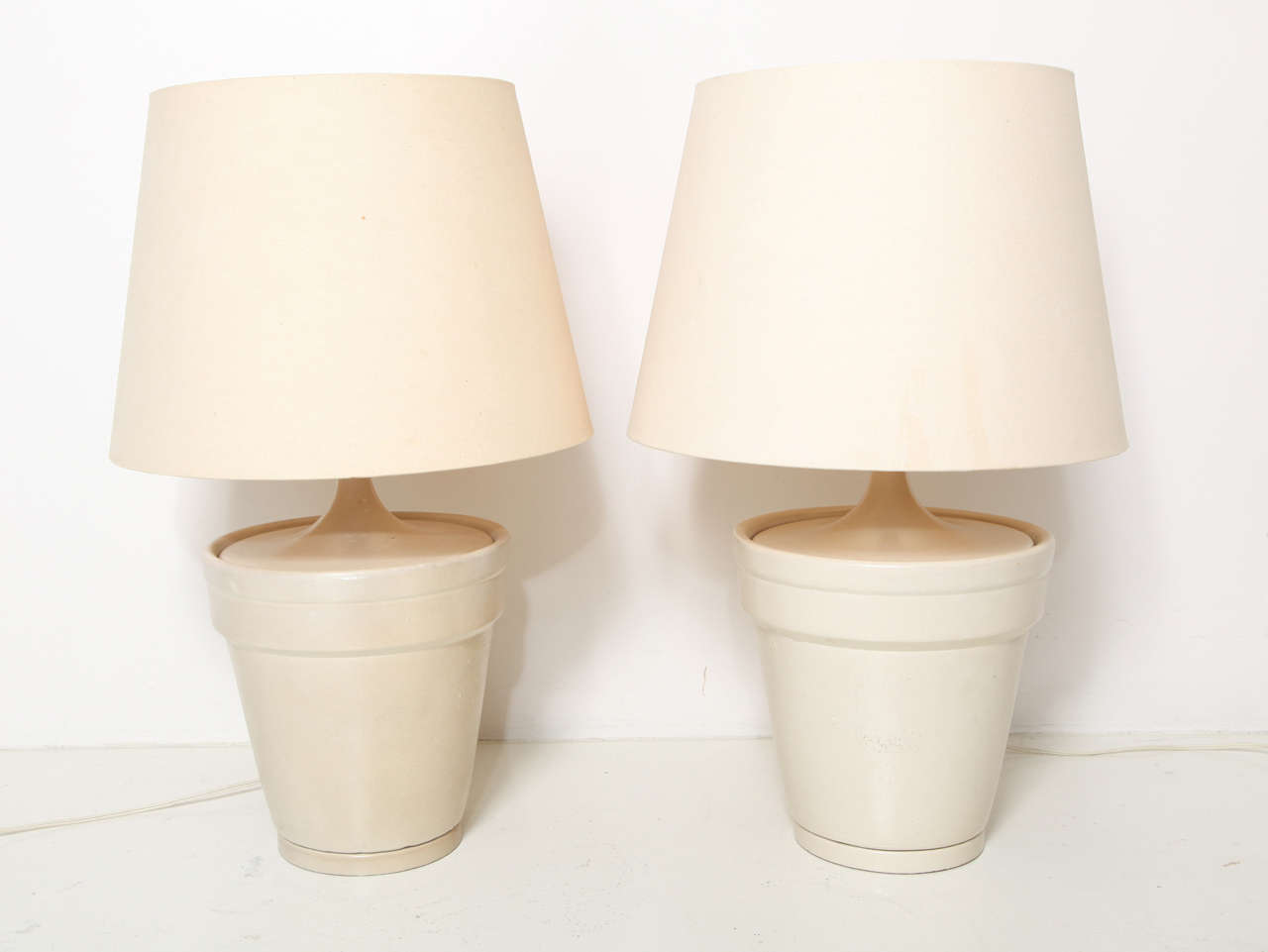 JOHN DICKINSON  (1920-1982)
Pair of painted terracotta lamps with wood fittings.
American, c. 1965
PROVENANCE:
Residence of Mr. and Mrs. Donald Magnin, San Francisco, CA
MEASUREMENTS:
11