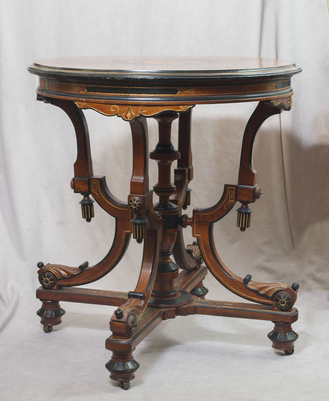 This is a very nice example of the most sought after style of the Victorian period, Renaissance Revival.  It has lovely marquetry on top and is partially ebonized and is in the original finish.