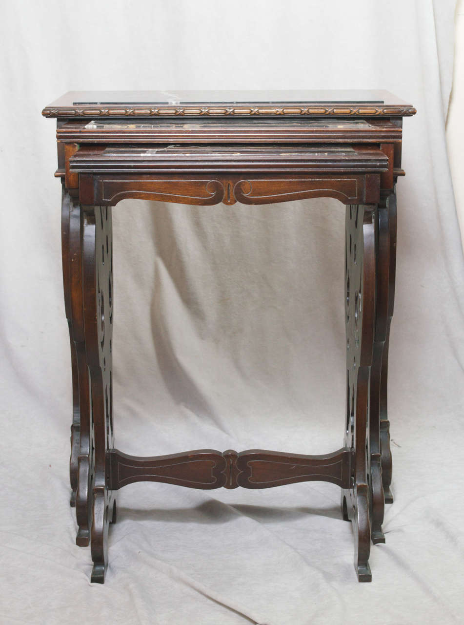 One of the highest quality nests of tables we have ever seen. Beautiful carved mahogany and exceptional marble highlight this functional and aesthetic furniture. The smaller tables slide in and out with great ease, as there is felt lining to aid in