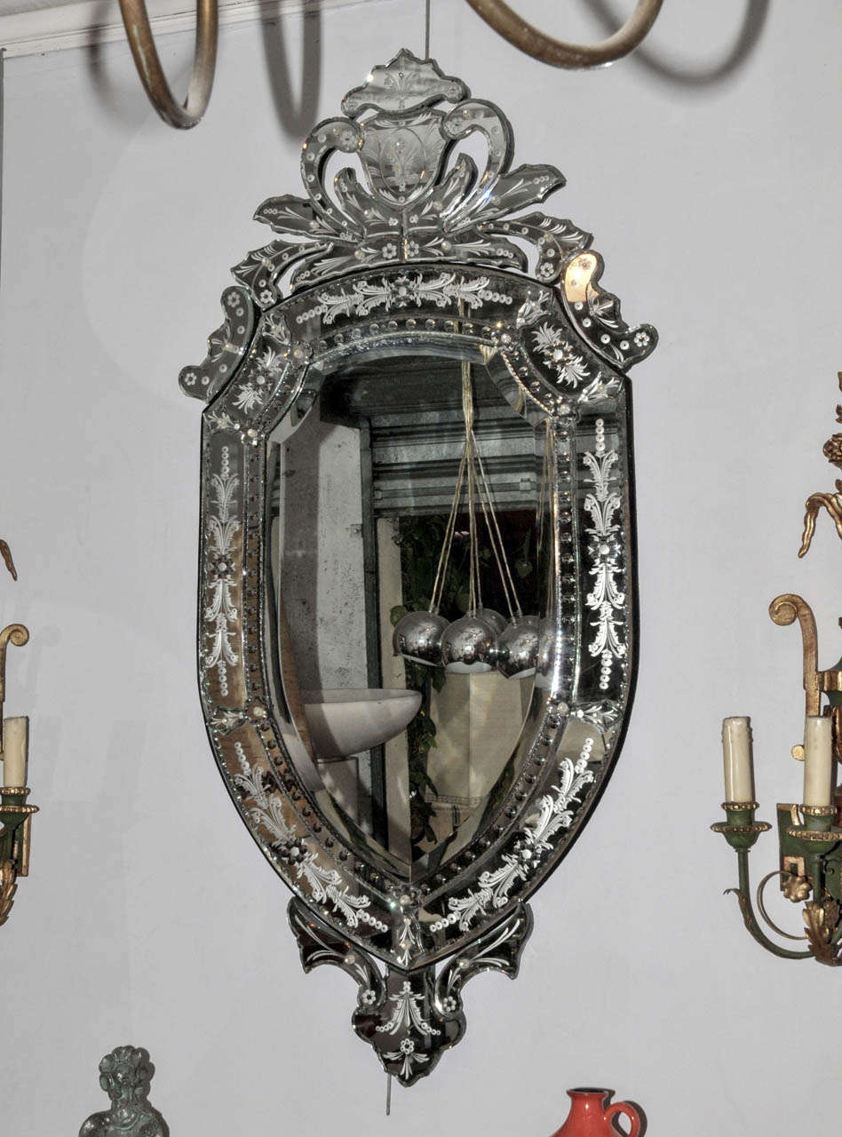 1960's Venetian style mirror. Engraved and beveled mirror. Good condition. Normal wear consistent with age and use.