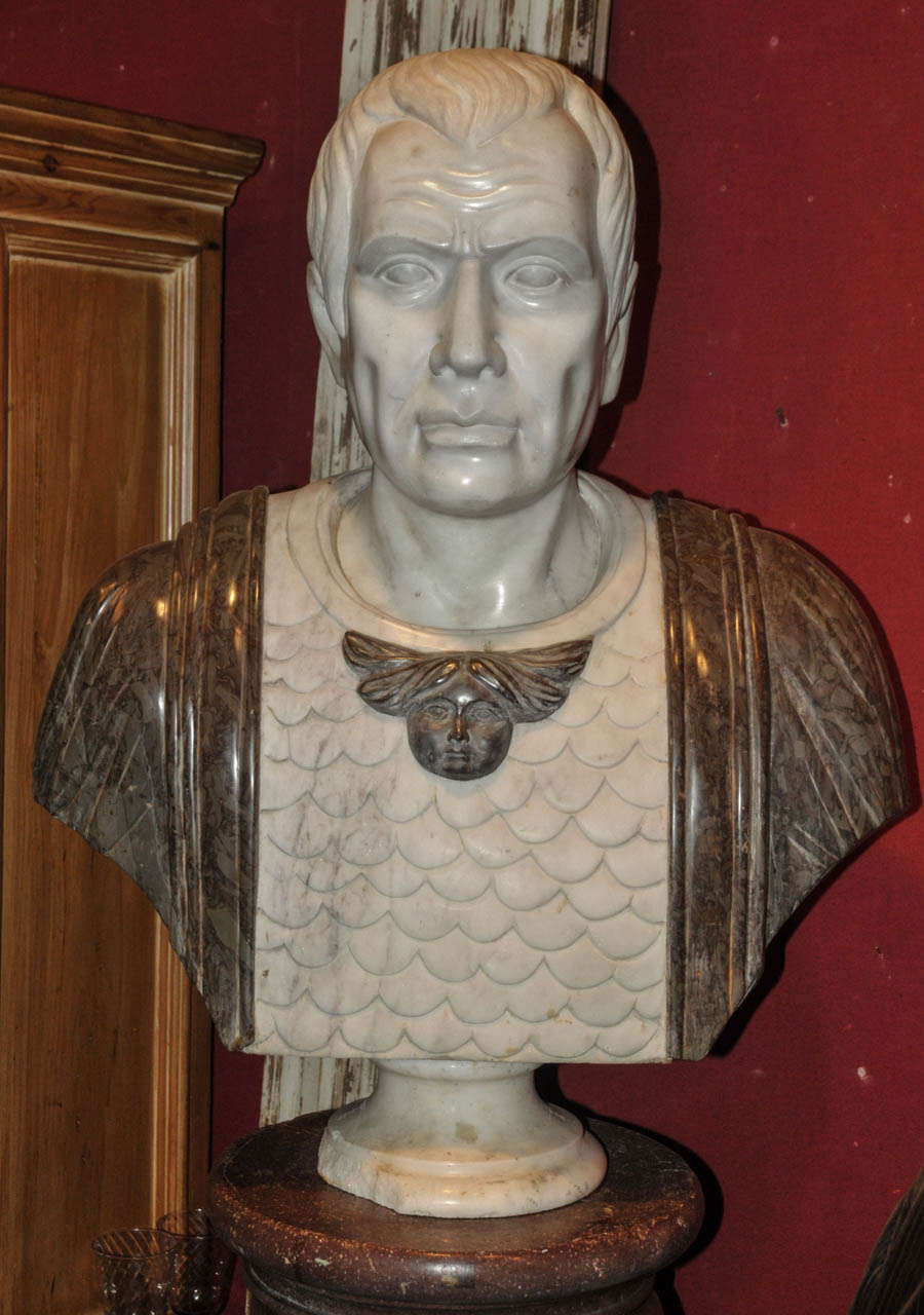 1920's white and grey-brown marble bust sculpture representing a Roman Emperor. Some splinters on the marble base. Normal wear consistent with age and use.