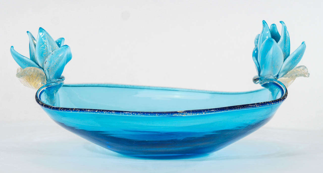 This lovely and large scale handblown crystal centerpiece made by Alfredo Barbini, will be the focal point of a special turquoise table setting. Modern in feeling and design, the undulating rim is embellished with gold leaf and catches the light