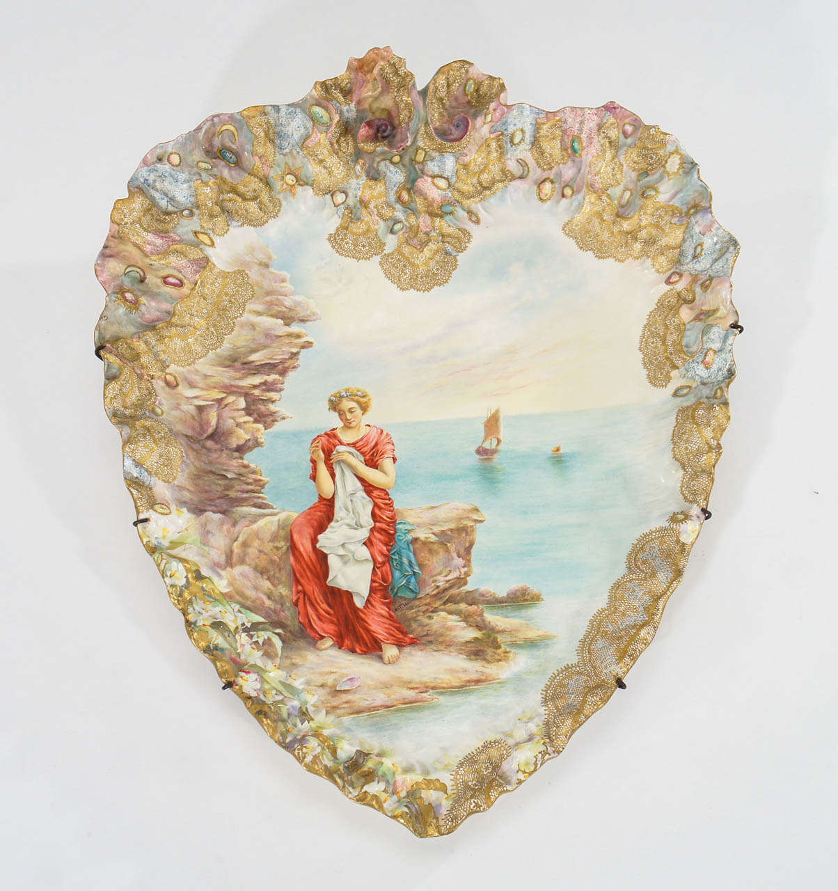 A rare and extraordinary large heart-shaped porcelain plaque is made by G. W. Turner, Tunstall, England dating from 1890s. The raised and molded border is a work of art unto itself with a soft Impressionistic palette with a jewel-like painting and a